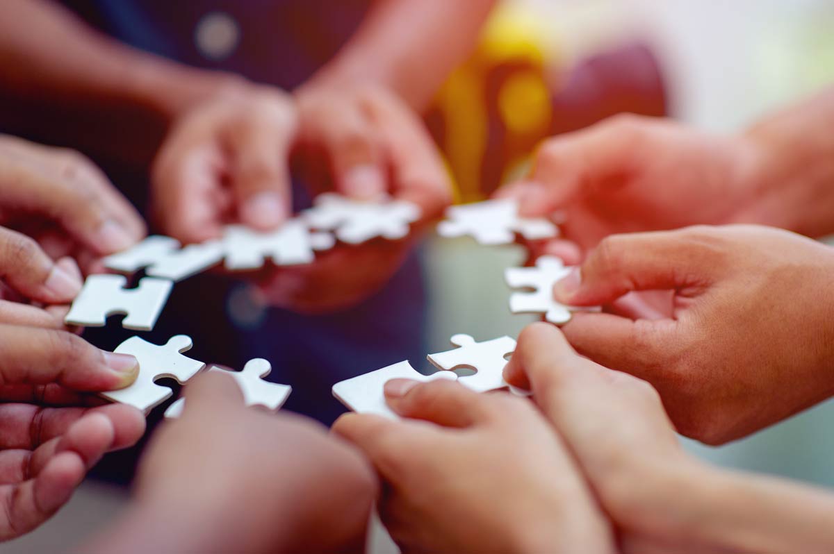 optiimized-team-work-hands-jig-saw-unite-with-power-is-good-team-successful-people-team-work-concept